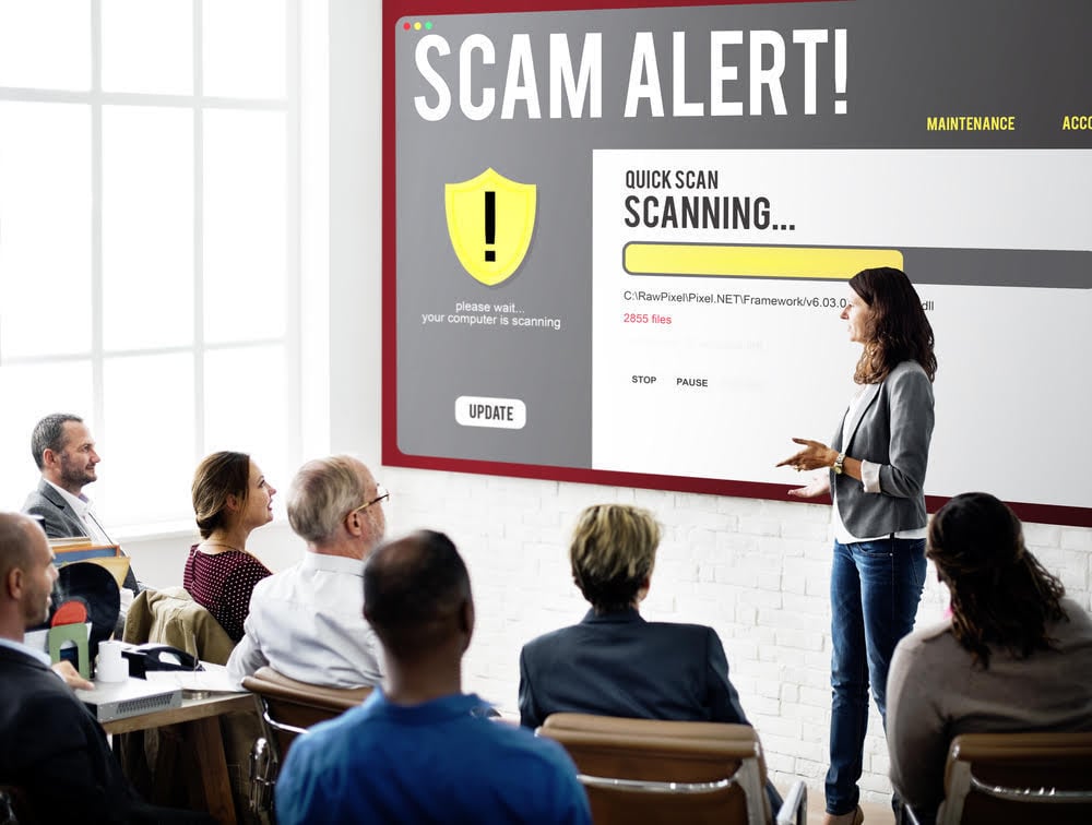 woman conducting phishing awareness training for employees scam alert